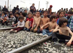 Protesting children with naked upper bodies sitting on train tracks at the Greek-Macedonian border in Idomeni, Greece, 21 March 2016. PHOTO: JOANA NIETFELD/dpa